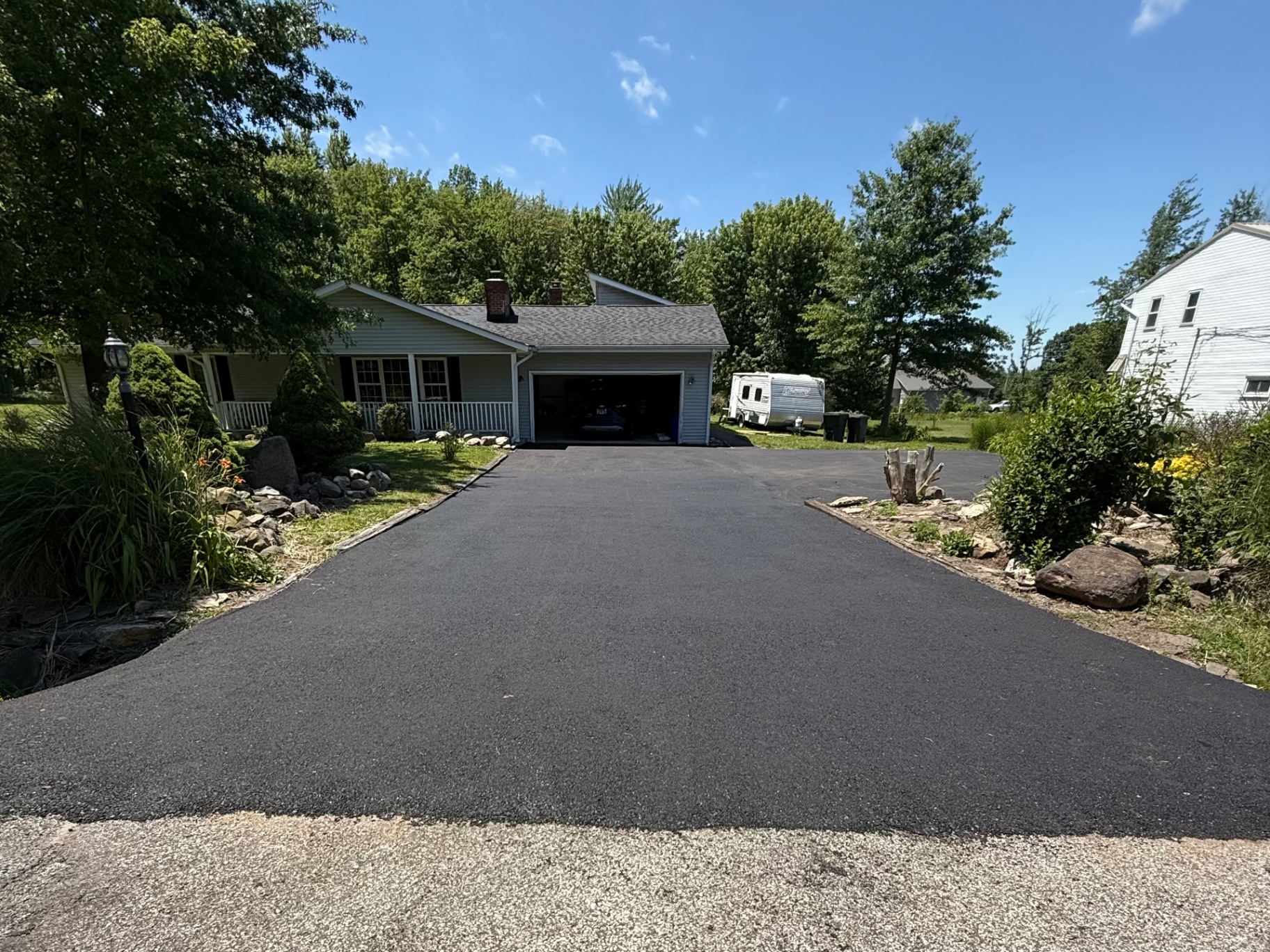 Resurfaced asphalt driveway leading to home in Concord Township
