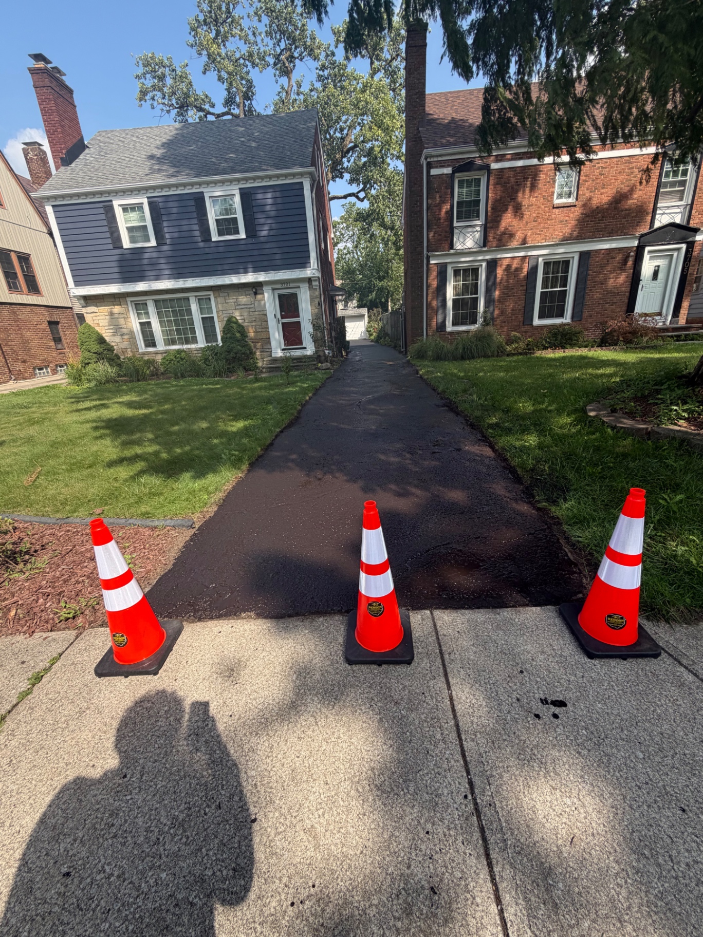 Sealed asphalt driveway with Rendon Paving cones in Shaker Heights
