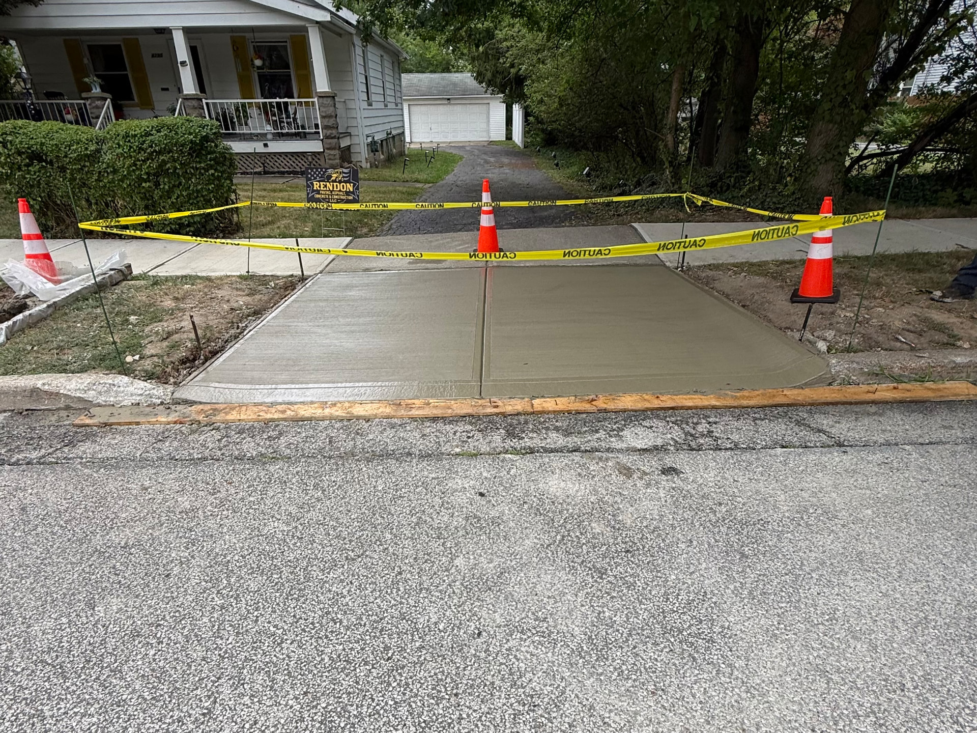 After: concrete driveway apron replacement in South Euclid, OH, freshly poured concrete with a clean broom finish by Rendon Paving
