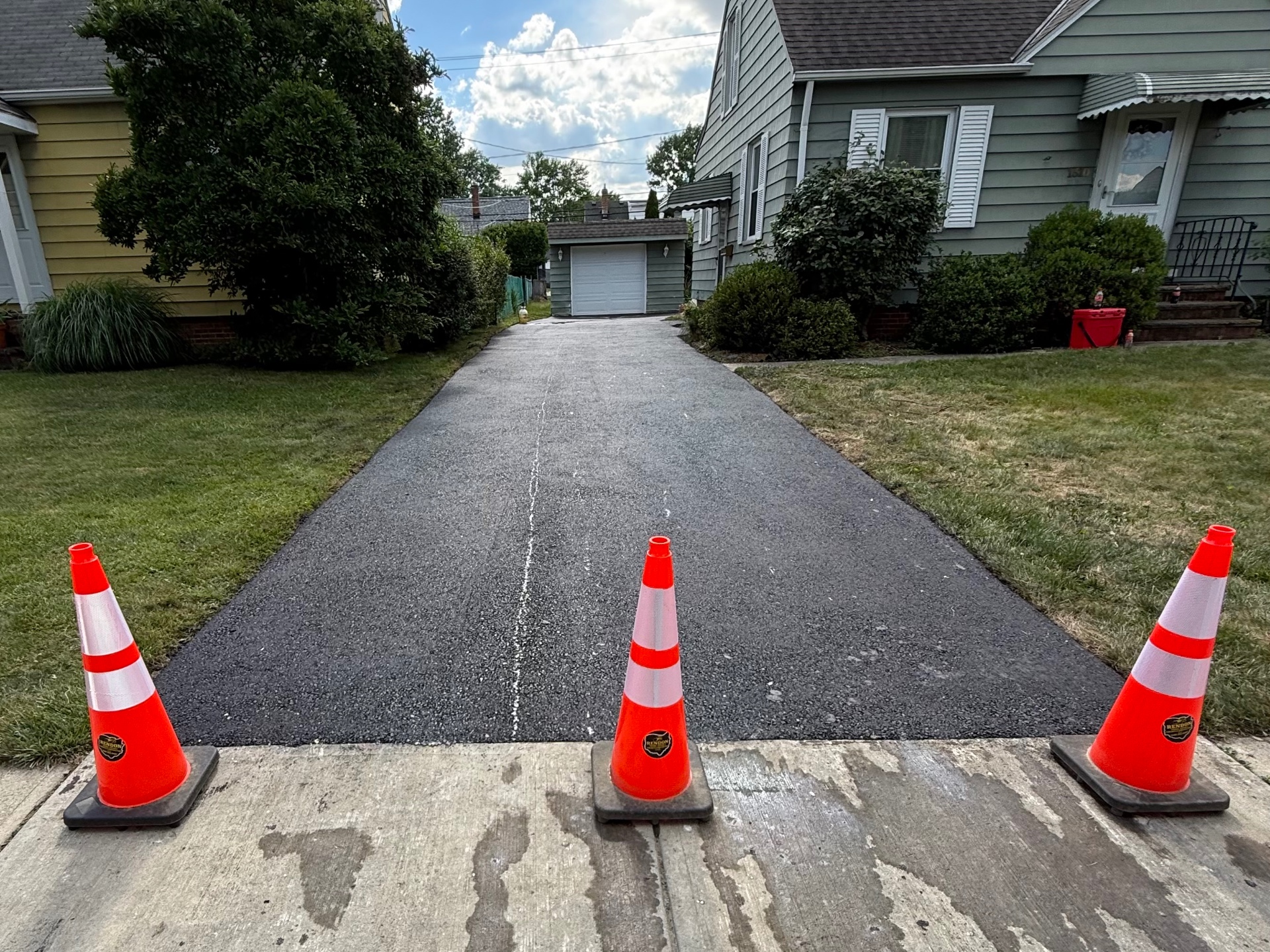 New asphalt driveway with Rendon cones in Mayfield Heights